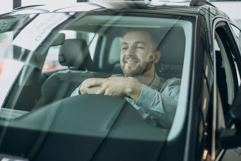 Automobilista alla guida con parabrezza in perfette condizioni